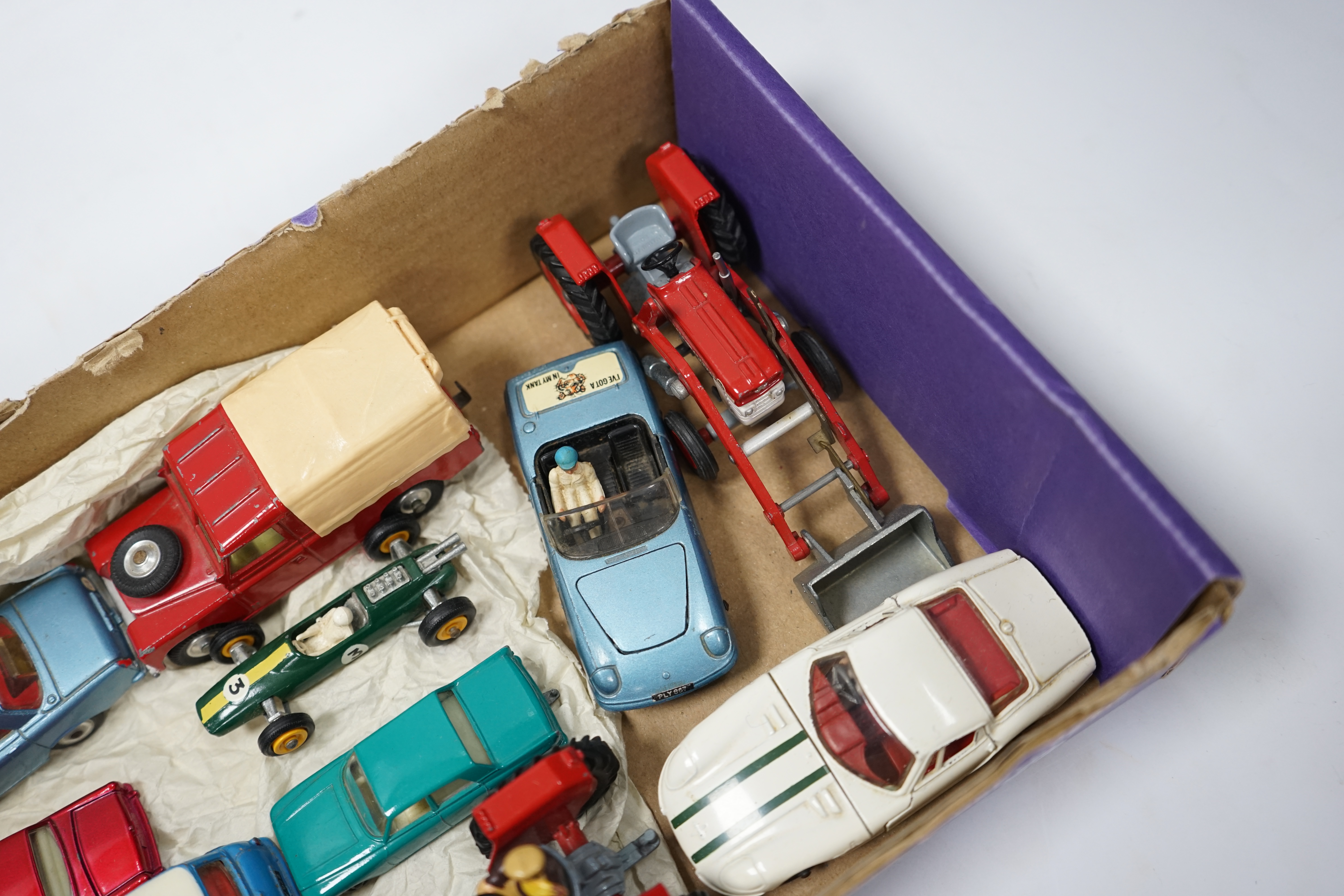 A collection of Corgi Toys and Matchbox series diecast vehicles, including a Lotus Elan 2, with ‘Tiger In My Tank’ decal, a Volvo P1800, Morris Mini Cooper, a Land Rover, a Rover 2000, a Massey Ferguson tractor shovel, e